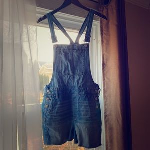 Blue denim overall shorts.